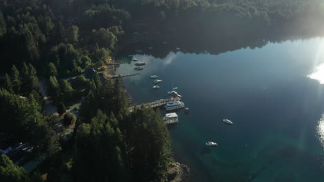 Aerial---Bahia-Brava-Bay-And-Pier,-Villa-La-Angostura,-Neuquen,-Argentina,-Forward-Lowering