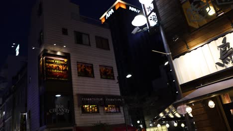 nighttime view of a lively urban street scene