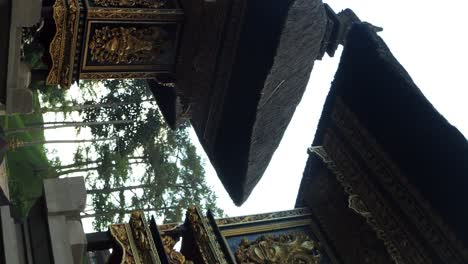 vertical slow motion upwards shot of temple building in pura tirta empul water temple in ubud on bali indonesia