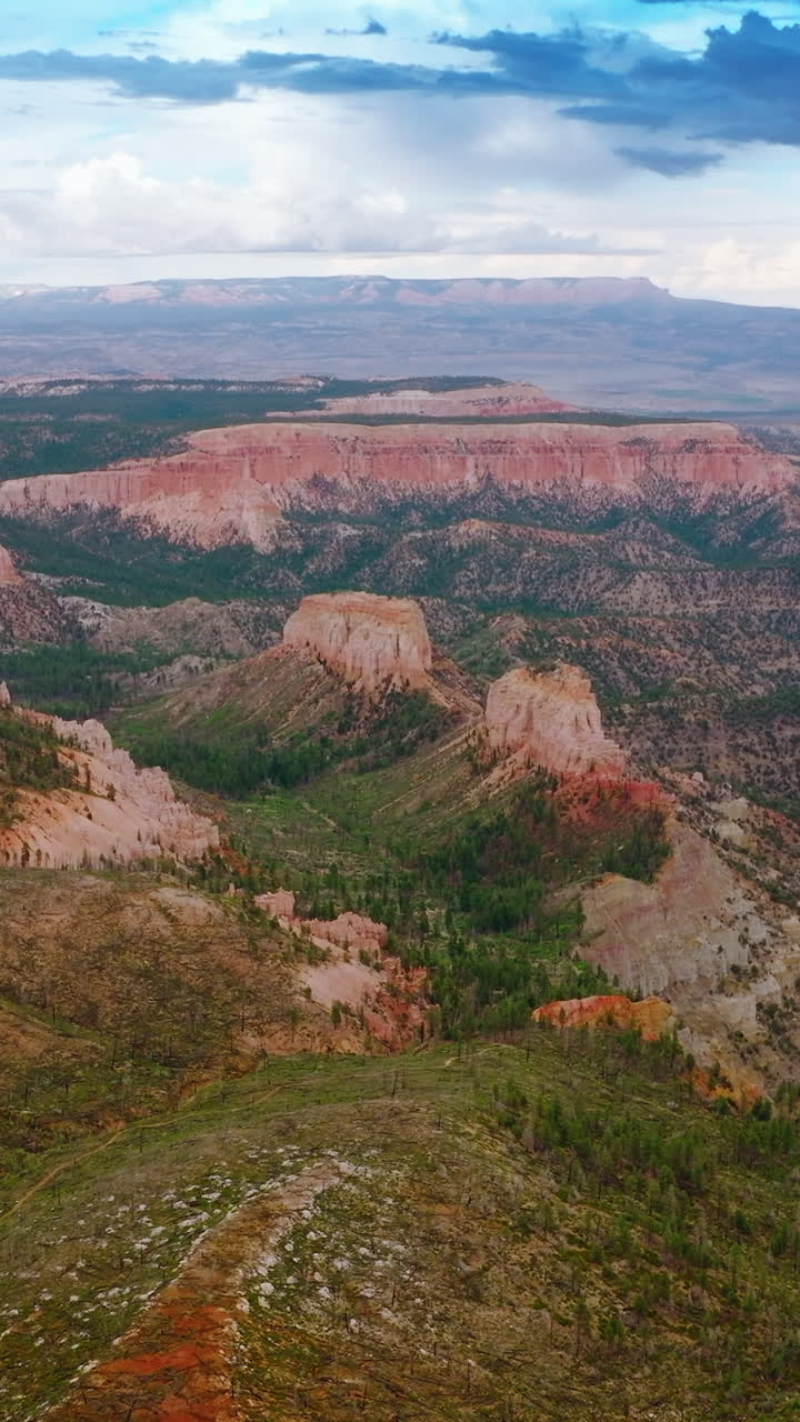 Amazing scenery of stunning mountains in Zion National park, Utah, USA. Cloudy sky over great canyons at backdrop. Aerial view. Vertical video