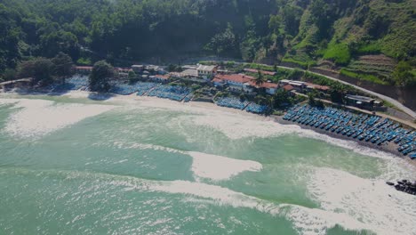 Aerial-view-of-view-beach-full-of-fishing-boats-that-anchored-on-the-coastline