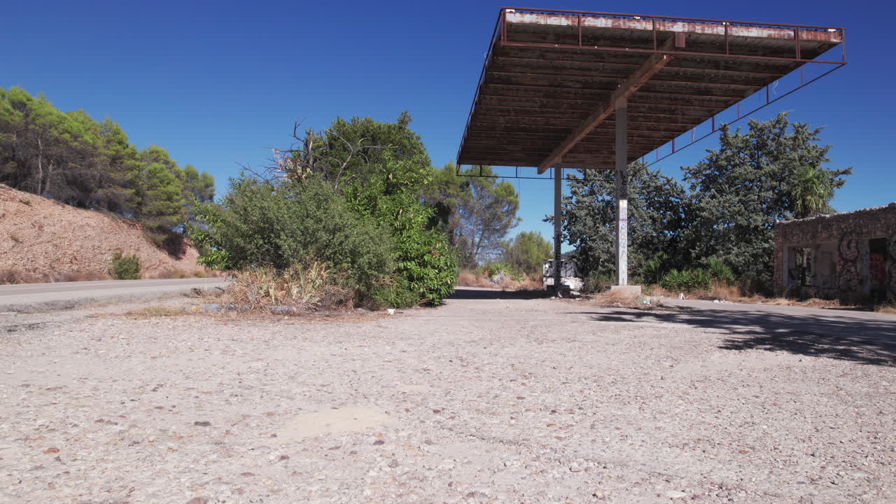 Panoramic shot of countryside road and abandoned gas station near the Embalse de Entrepeñas reservoir, Spain