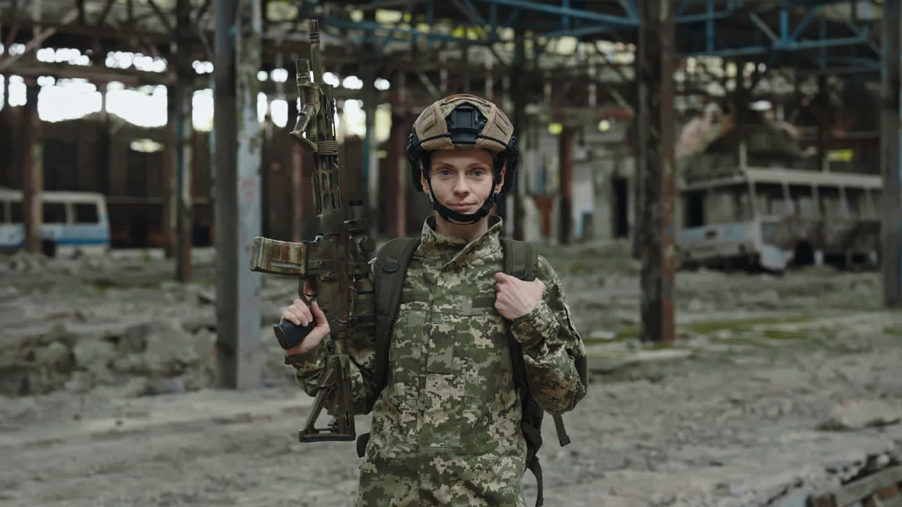 Woman Soldier with Rifle in Abandoned Factory