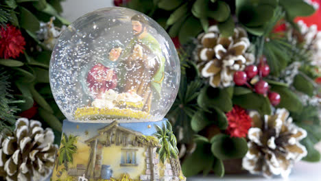 snowglobe with child in the manger on christmas background