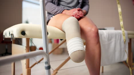 doctor measuring a patient's prosthetic leg