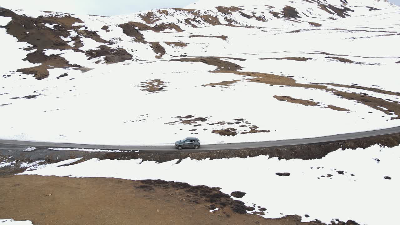 Spiti district of Himachal Pradesh World's Highest Village india Komic indian tourist driving a car along the mountains road, aerial view