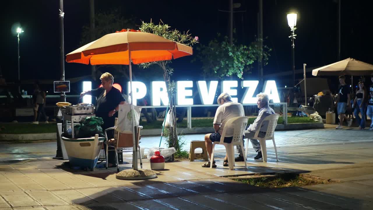 Food stall in front of the town lighted sign