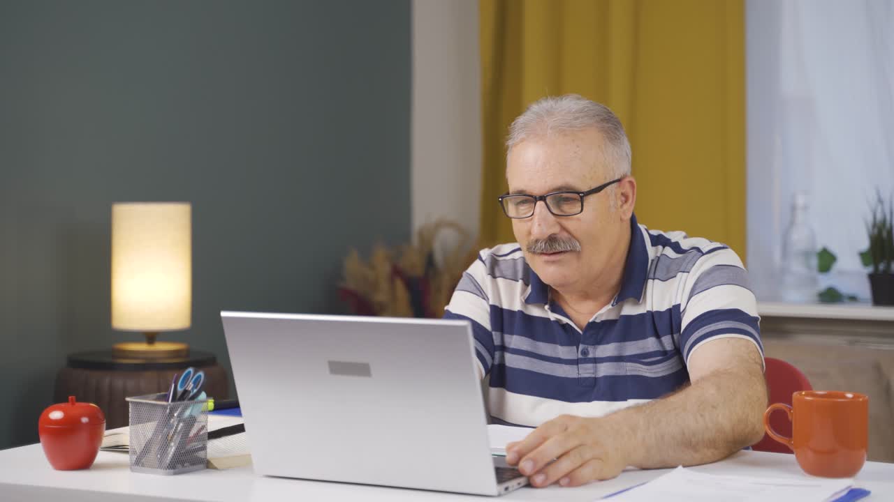 Home office worker old man looking with satisfied expression.