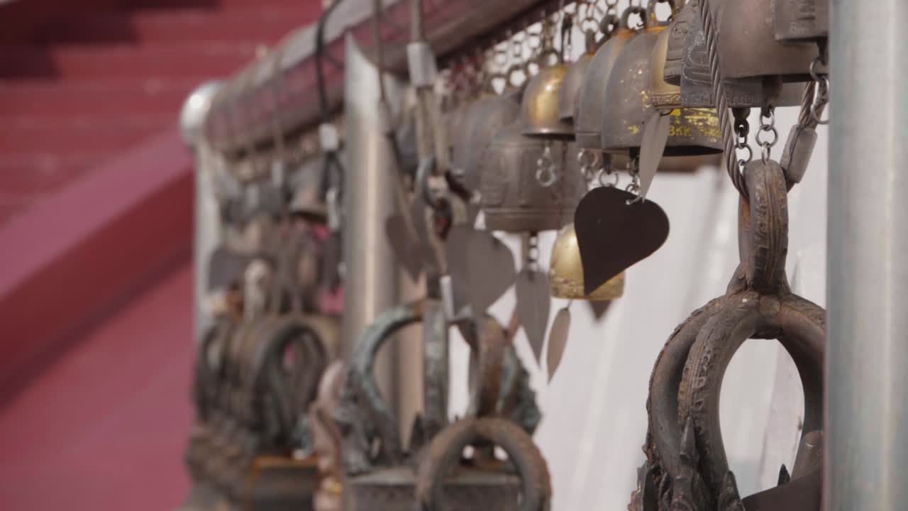 Bells Swinging in the Wind at Buddhist Temple. Camera Movement. Slow Motion.