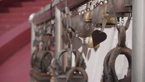 bells swinging in the wind at buddhist temple. camera movement. slow motion.