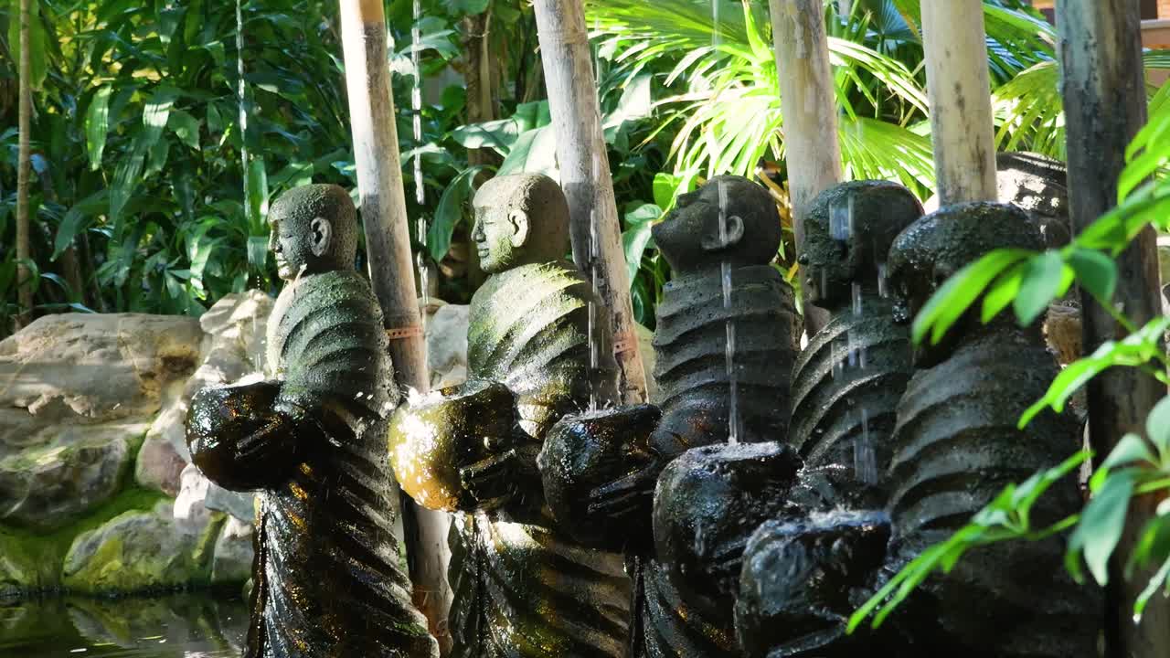 Row of Monk Statues in Garden Setting