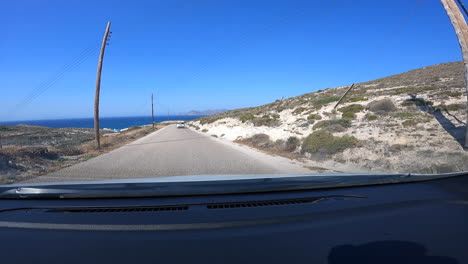 View-behind-the-windshield-of-a-desert-road