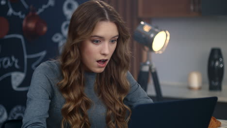 Focused-business-woman-getting-message-on-laptop-computer-at-home-office.