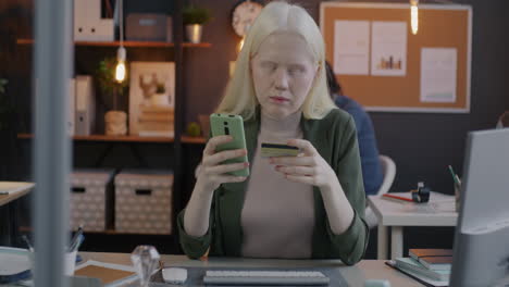 woman making a mobile payment in the office