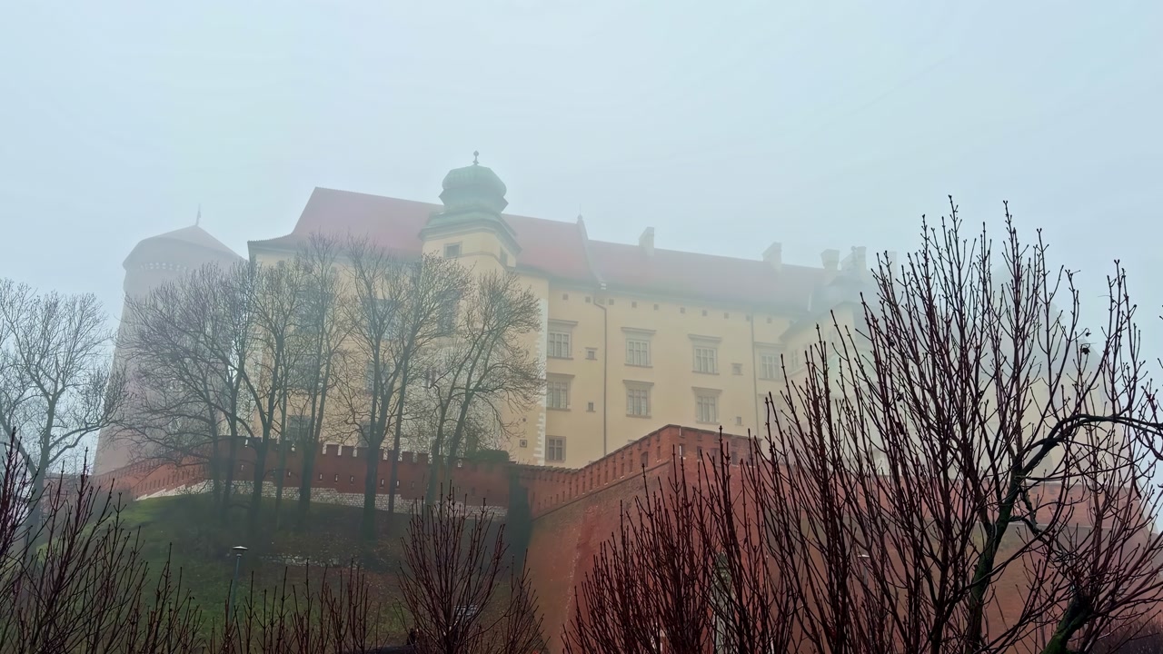 Misty view of Wawel Royal Castle in Krakow, creating a serene atmosphere