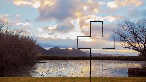 sunset casting silhouette of cross over serene lake and mountain landscape