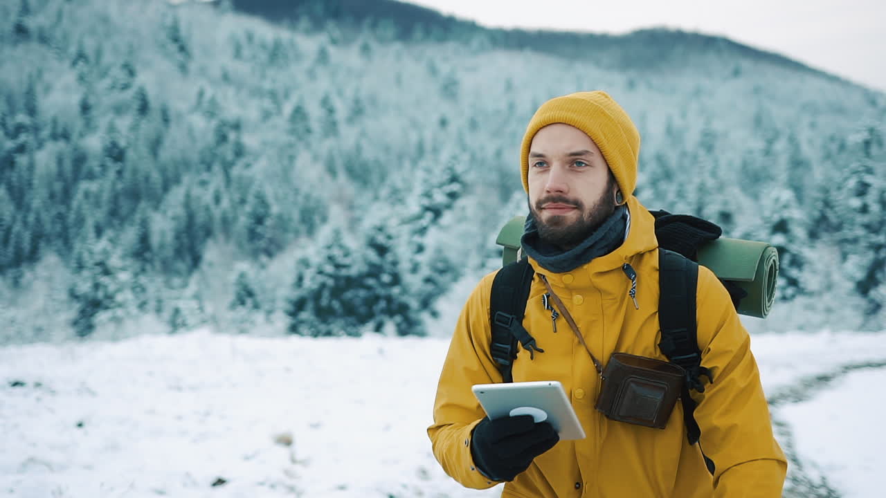 Man with Tablet in Winter Landscape