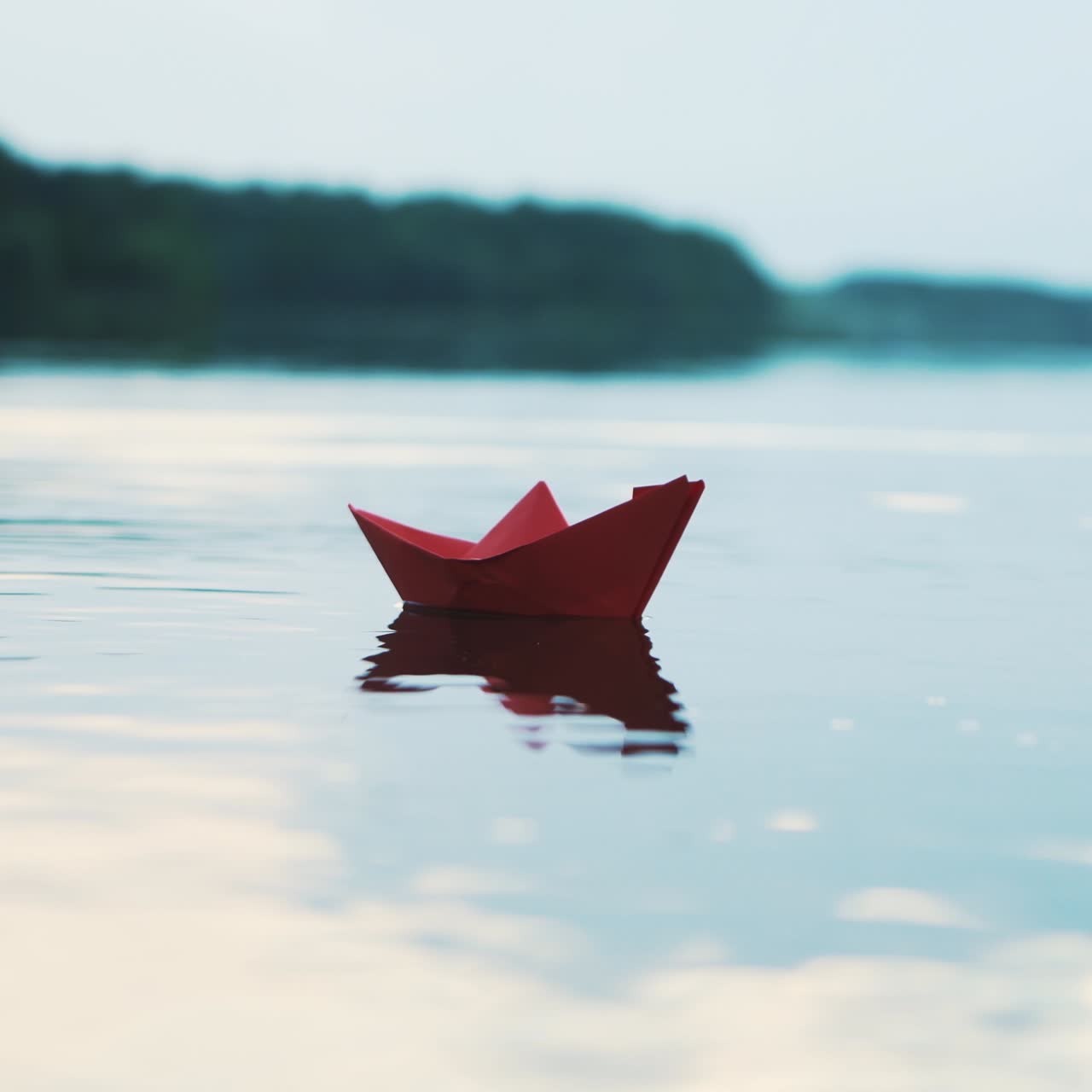 Paper boat floating on water