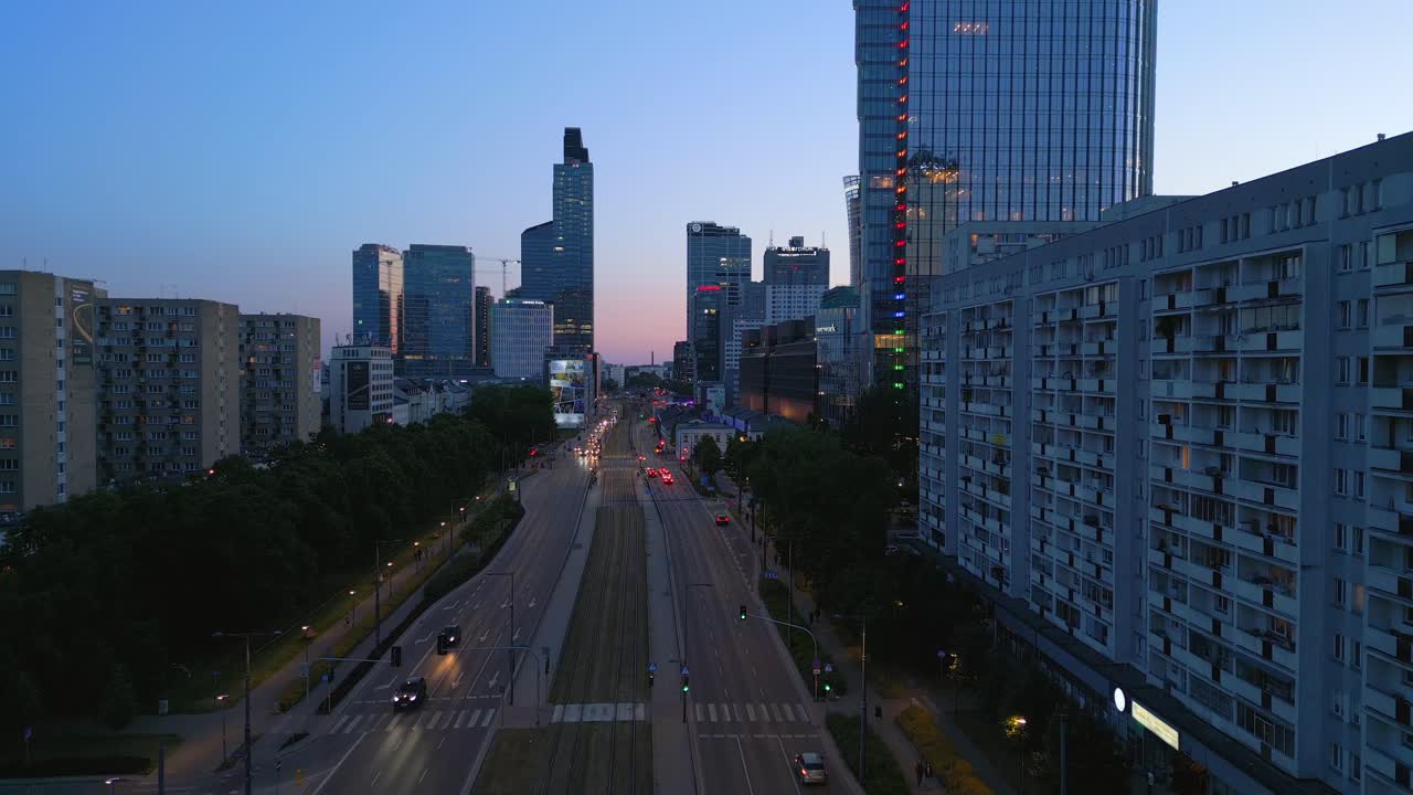 Aerial footage of Warsaw's evening city traffic on a weekend, flying towards Rondo Daszynskiego with its new modern offices in the bustling financial center
