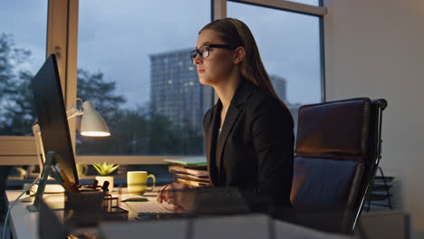 focused manager working late in office. successful ceo woman surfing internet