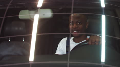 man driving a futuristic car at night