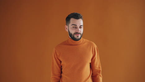 man in an orange sweater