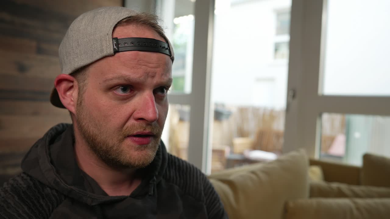 GAMING - Millennial man focuses on a video game, slow motion close up