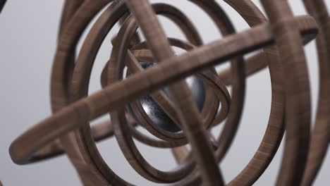 metallic sphere and wooden rings. abstract 3d animation.