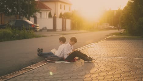 students sitting on road prepare for exam against sunlight