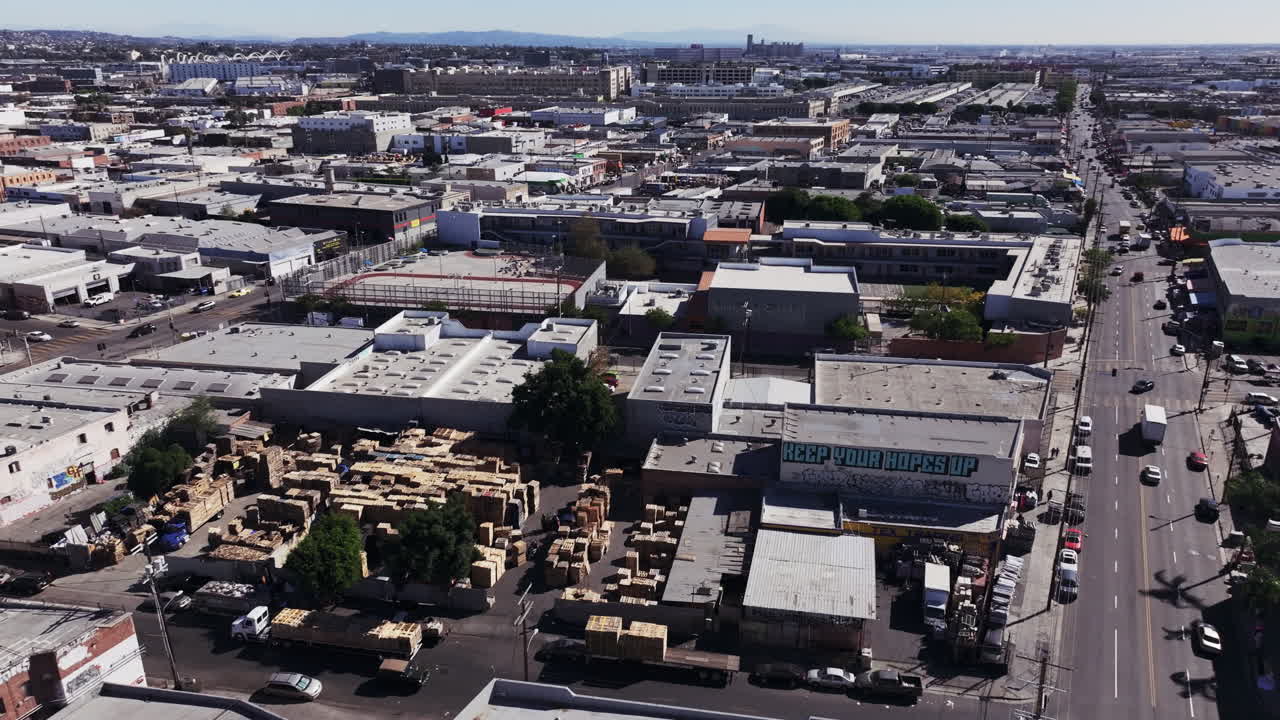 Aerial view of an urban industrial district with lumber yards and city streets