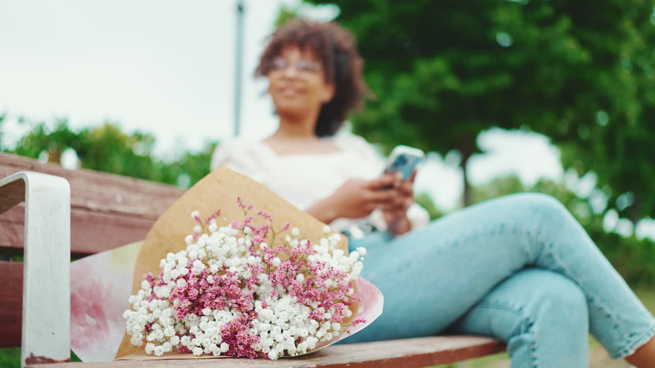 Woman with flowers on a park bench