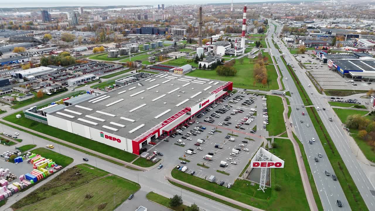 DEPO warehouse in Klaipeda with large parking lot and surrounding roads captured from above