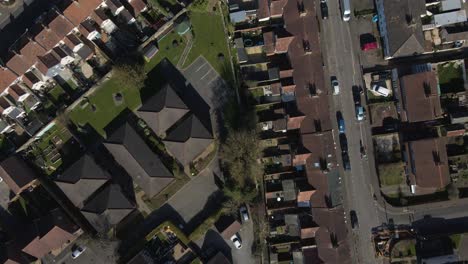 4k aerial view of a residencial area in taunton somerset, united kingdom, drone moving forward and showing the buildings roofs and street