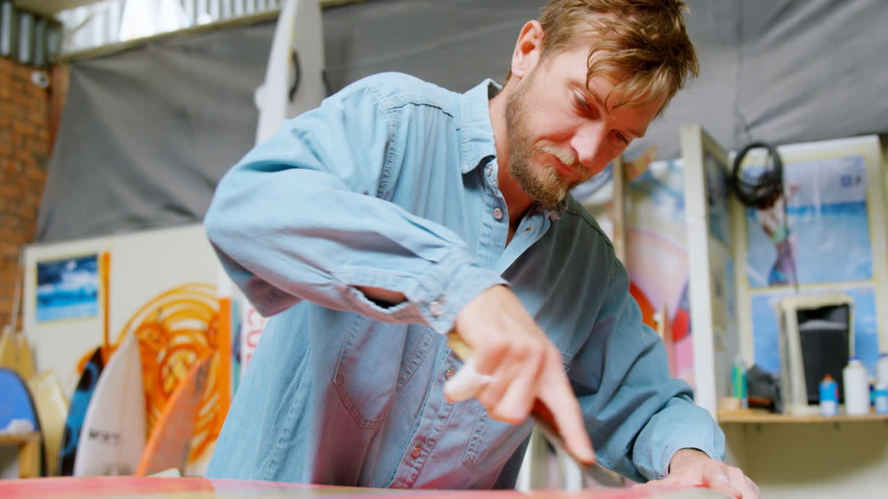 Man making surfboard 4k