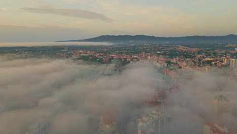 light clouds covering town at summer evening drone view. majestic coastal city