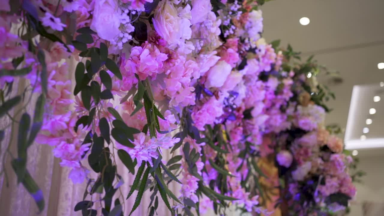 A stage of a wedding venue decorated with colorful flowers, A close up view