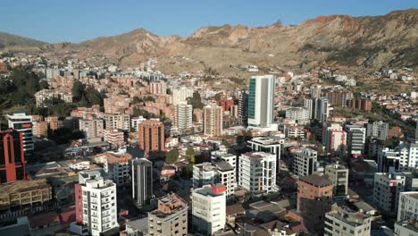 Aerial-drone-panning-shot-over-city-buildings-of-El-Alto-and-La-Paz-over-Andes-mountains-in-Bolivia-on-a-sunny-morning