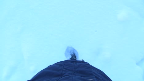 pov person leaving footsteps in thick layer of snow
