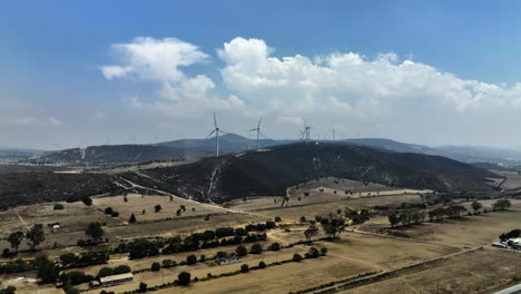 aerial view rising toward the eolic park, sunny day in esperanza, puebla, mexico