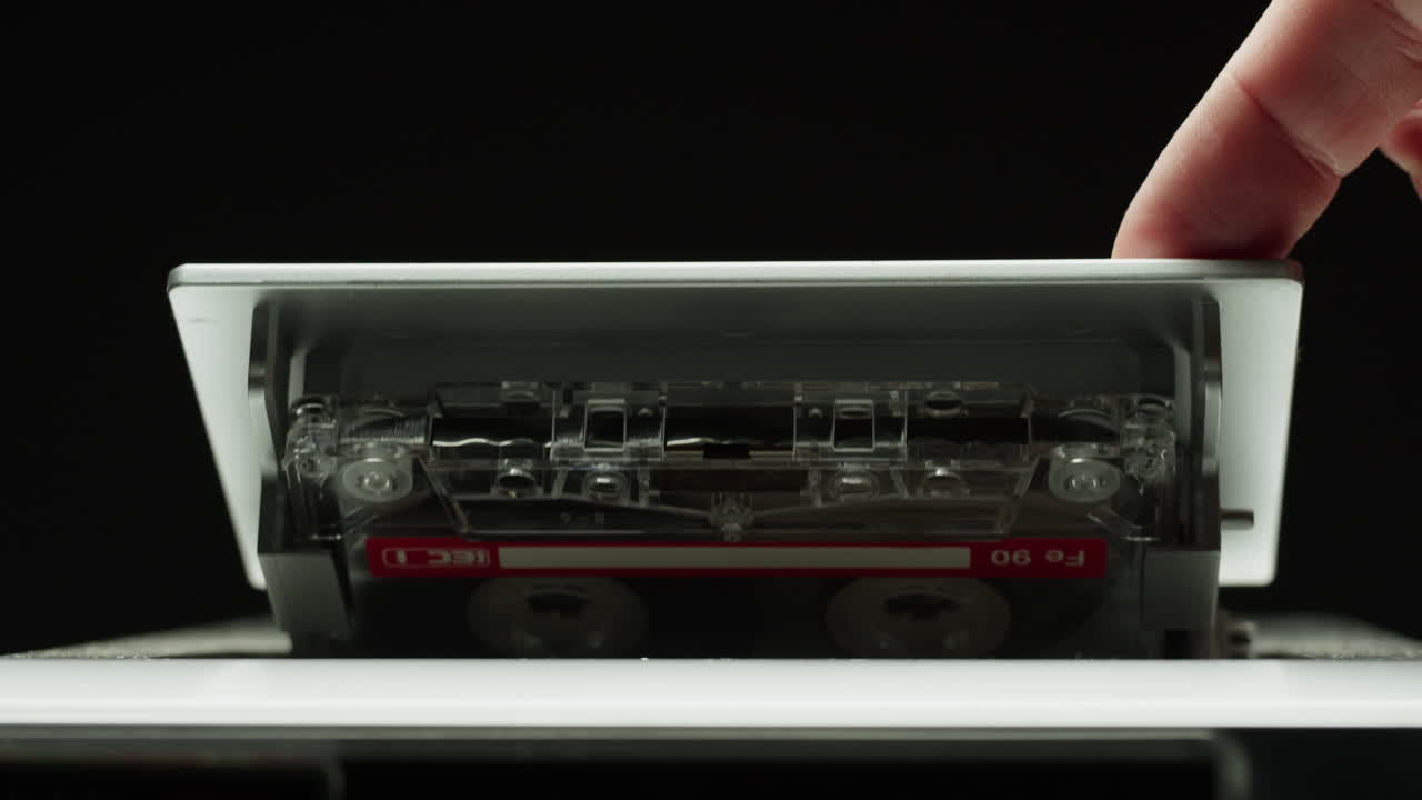 Cassette tape player, Close-up of a spinning vintage audio cassette in tape recorder. Retro magnetic cassette plays music. selective focus, shallow depth of field