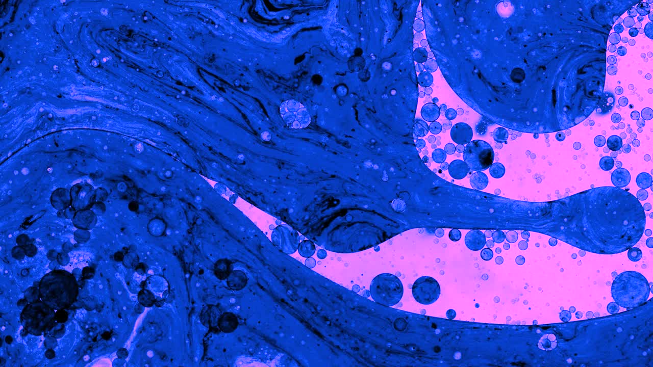 Colorful oil drops floating on water surface, top view. Fantastic abstract background. Bright bubbles moving and spreading. Close up 4k video of weird liquid structures. Scientific chemical experiment