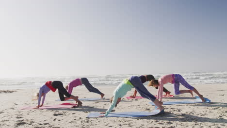 animation of text vibes, in white and black, over women exercising on beach