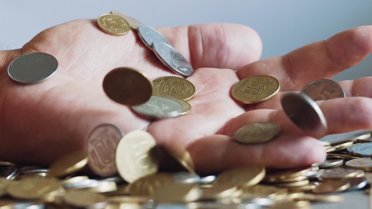 Man is holding coins in his hands. Man's hands hold a lot of gold coins. Financial, business concept.