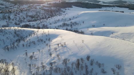 Over-the-hills-covered-with-snow-towards-sunset-or-sunrise