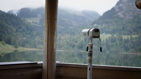 Smooth-dolly-moving-reveal-monocular-overlooking-scenic-mountain-lake