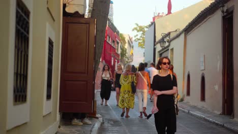 Streets-of-Athens,-Tourists-wandering-around-Greece,-Old-lady-with-colorful-dresses-walking-around