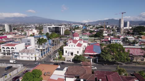 aerial view of san josé, costa rica, featuring santa teresita church and surrounding urban landscape with mountains in the background