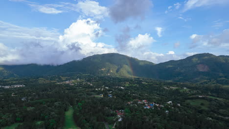 stunning natural rainbow in the mountains with an amazing forest and environment, amazing aerial view