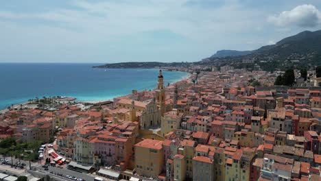 saint michel basilica church and seaside town buildings of menton in southern france, aerial orbit right shot