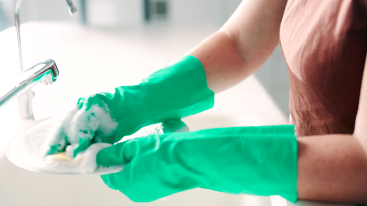 manos, esponja y lavado de platos en la cocina